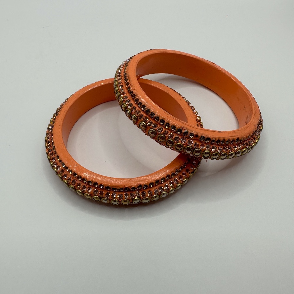 Two resin bangle bracelets with embellishments